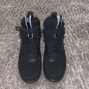 Black high top laced up sneakers